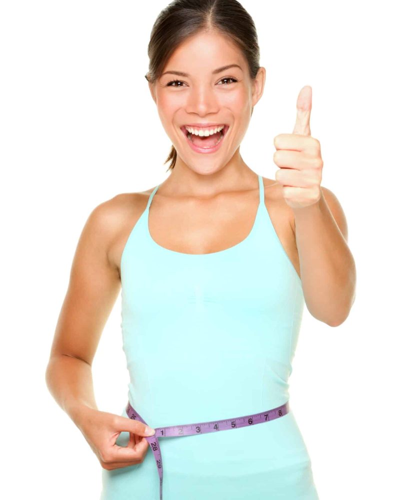 weight loss woman smiling happy excited standing with measuring tape giving thumbs up success hand sign isolated on white background. Asian female fitness model.