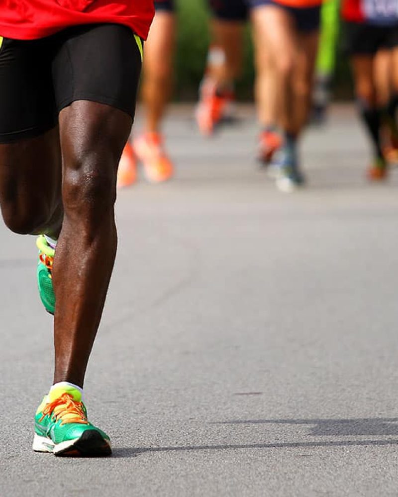 fast athlete runs down the street during the race outdoors